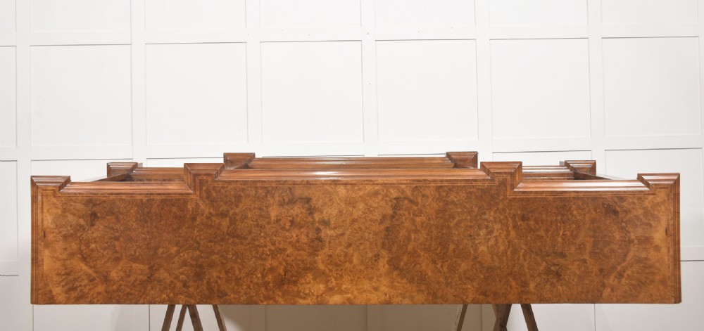 A low three-section breakfront open bookcase made from burr walnut veneer with adjustable shelves and a plinth base. View XIX