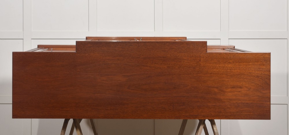 A flame mahogany breakfront sideboard featuring four panelled cupboard doors, four top drawers with brass drop handles, and fluted pilasters. View XI
