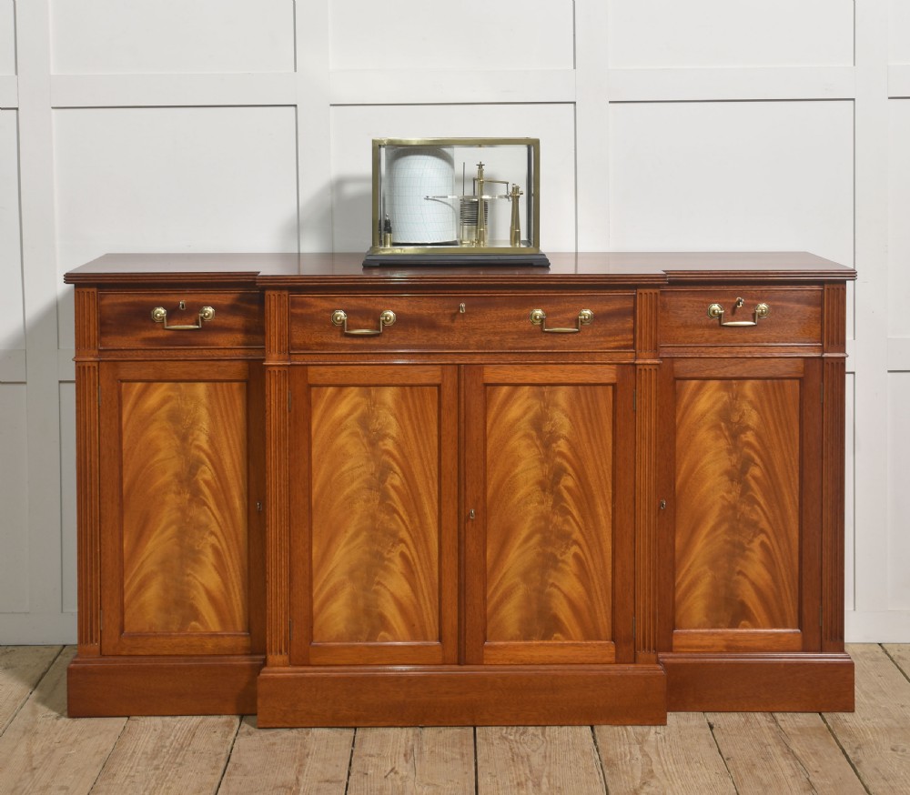 An antique brass-framed glass display case housing a scientific barograph mechanism with a paper chart drum, aneroid capsules, and pen arm. View II