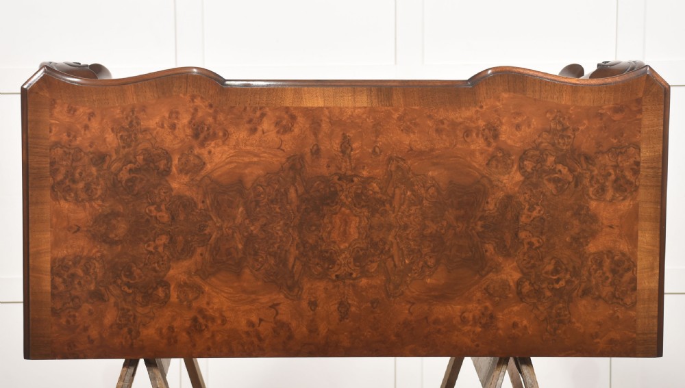 A burr walnut writing table featuring three drawers with brass handles and slender cabriole legs. View XV