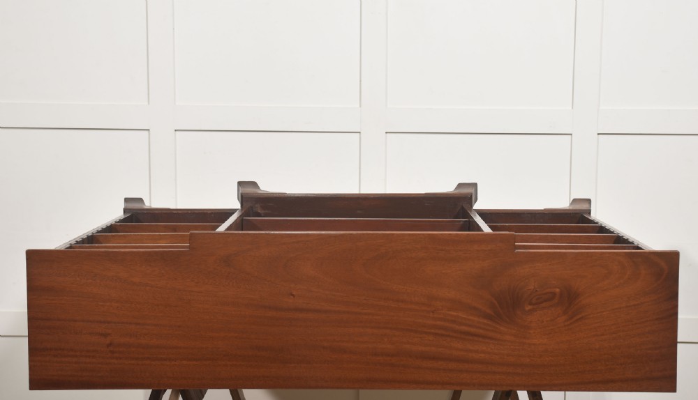 A low mahogany breakfront open bookcase featuring a reeded frieze top, adjustable shelf sections, and bracket feet. View XII