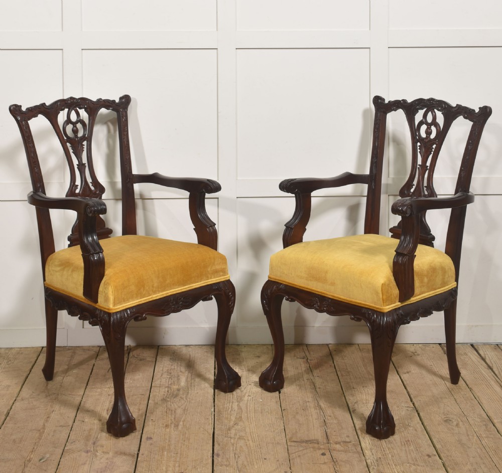 A set of eight dark mahogany dining chairs featuring elaborate pierced back splats, cabriole legs with ball and claw feet, and mustard yellow velvet upholstered seats. View VII
