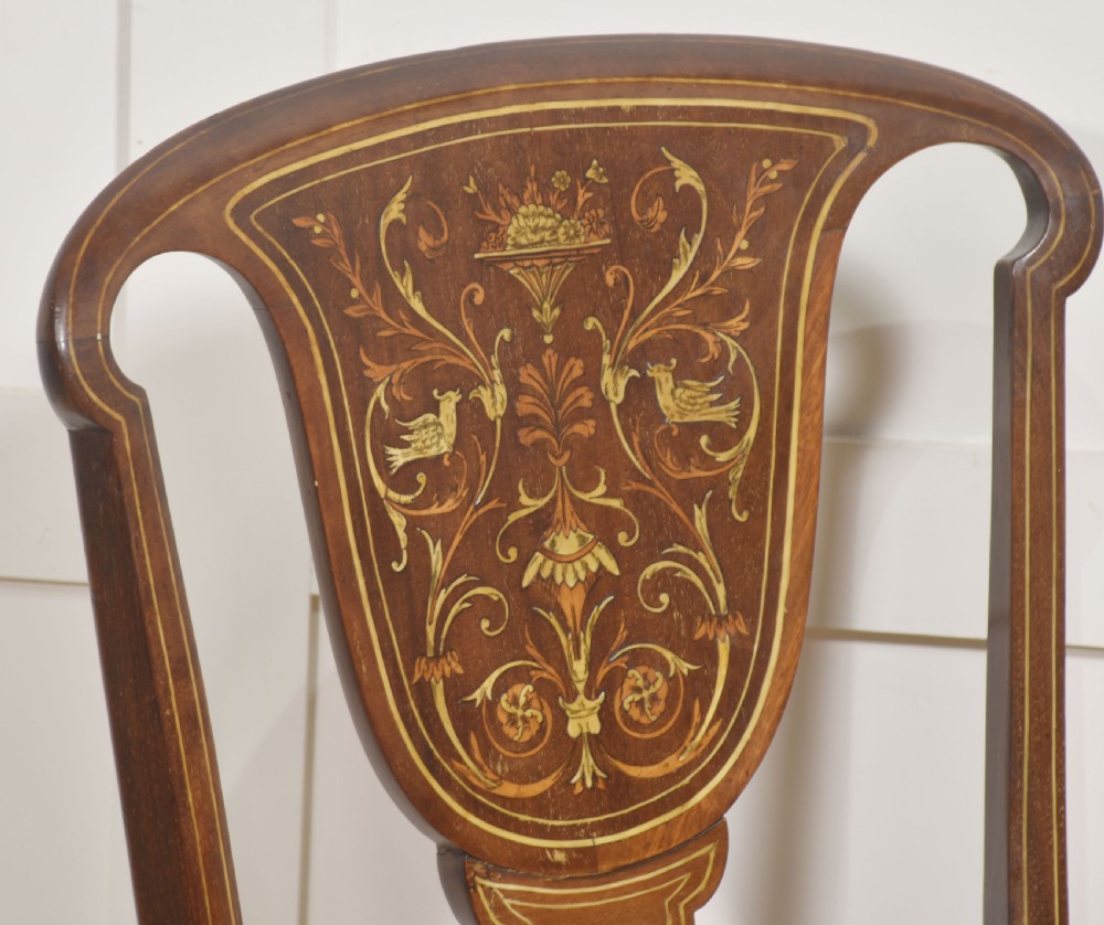 A pair of Edwardian inlaid mahogany side chairs with vase-shaped marquetry splats, cabriole front legs, and golden upholstered seats. View VII