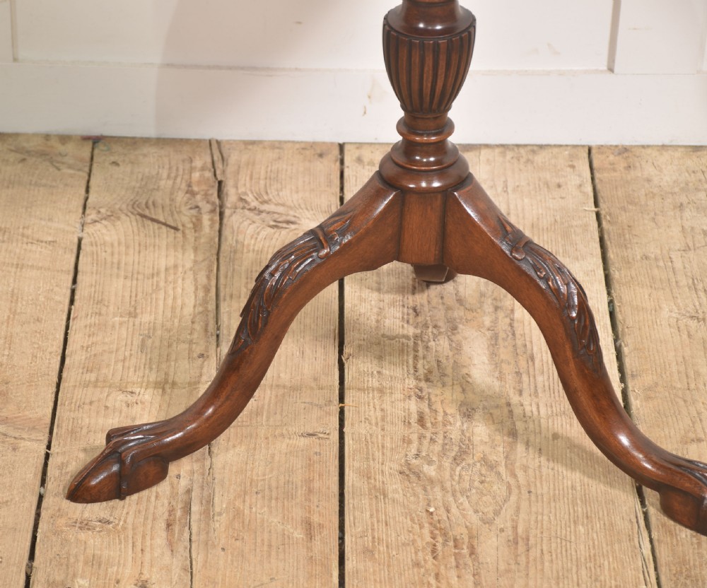 A George III style mahogany two-tier side table featuring graduated circular tops, a turned central column, and carved tripod legs. View VI