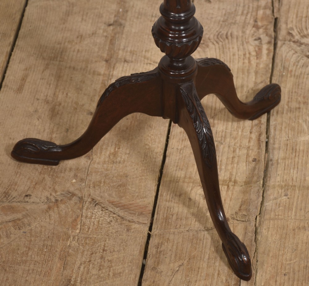 A dark mahogany occasional wine table featuring a pierced fretwork gallery top set on a turned tripod pedestal base. View IV