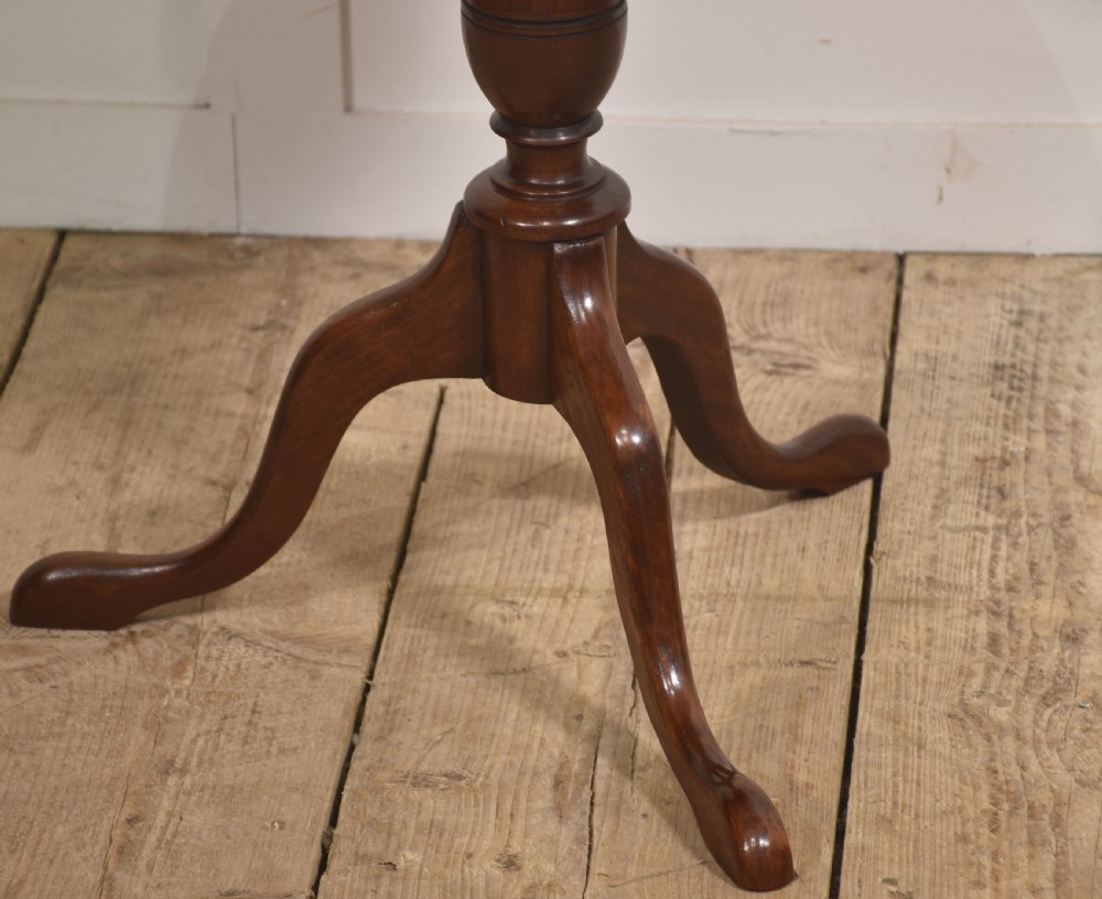 A Georgian style dark mahogany tripod wine table featuring a circular top with a moulded rim, a turned central pedestal stem, and three cabriole legs. View II