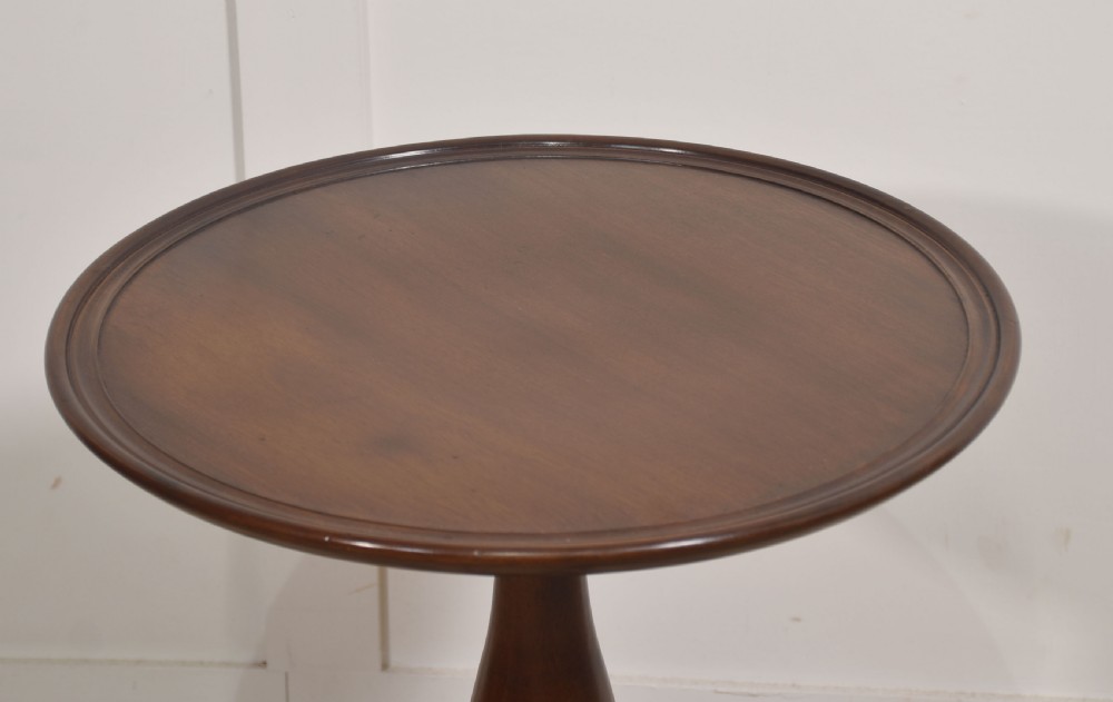 A Georgian style dark mahogany tripod wine table featuring a circular top with a moulded rim, a turned central pedestal stem, and three cabriole legs. View III