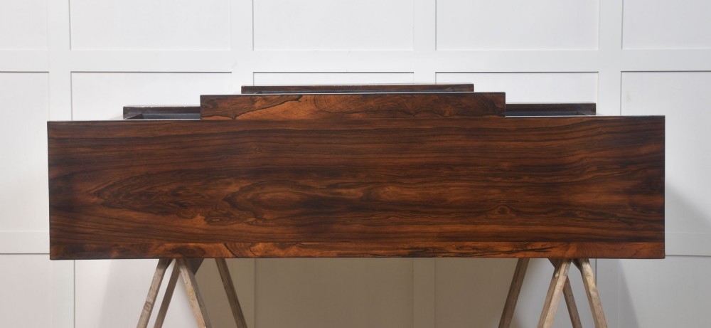 A large Victorian rosewood breakfront open bookcase featuring three shelf sections, carved barley twist columns, and a spindle gallery along the top edge. View VII