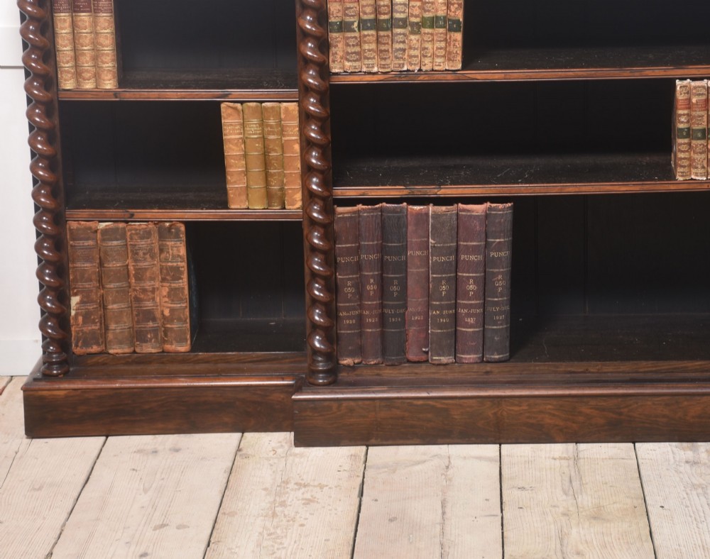A large Victorian rosewood breakfront open bookcase featuring three shelf sections, carved barley twist columns, and a spindle gallery along the top edge. View XIV