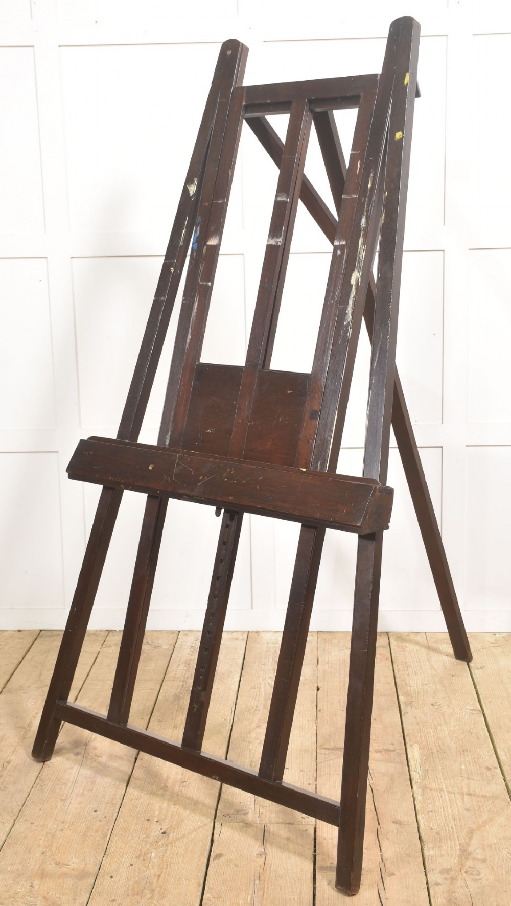 A large 19th-century mahogany floor-standing studio easel with a central adjustable shelf and an A-frame structure.