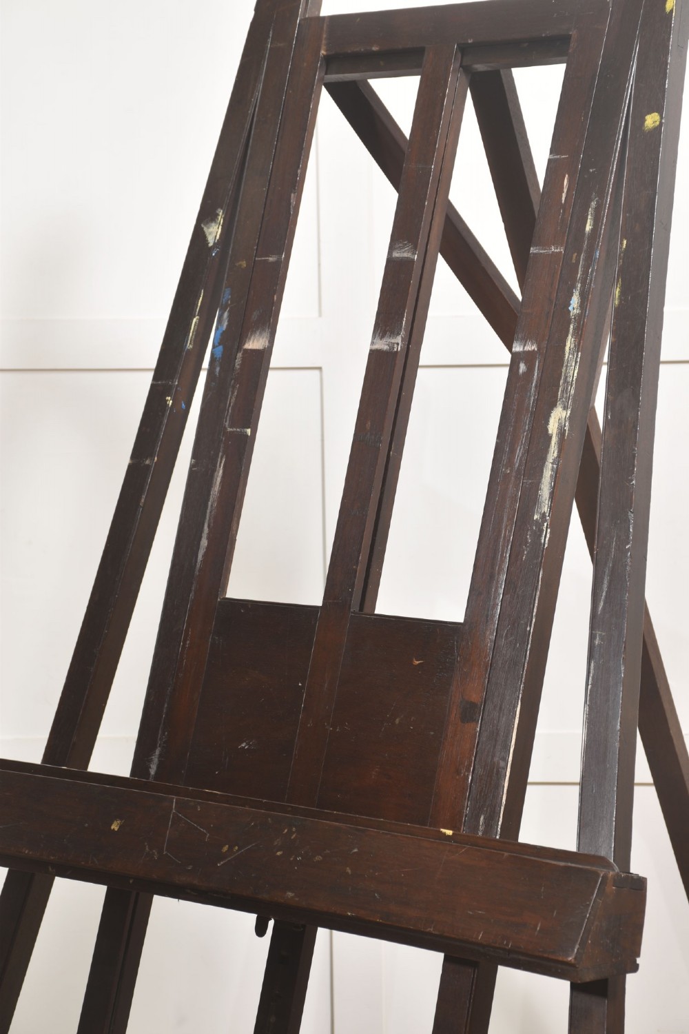 A large 19th-century mahogany floor-standing studio easel with a central adjustable shelf and an A-frame structure. View IV