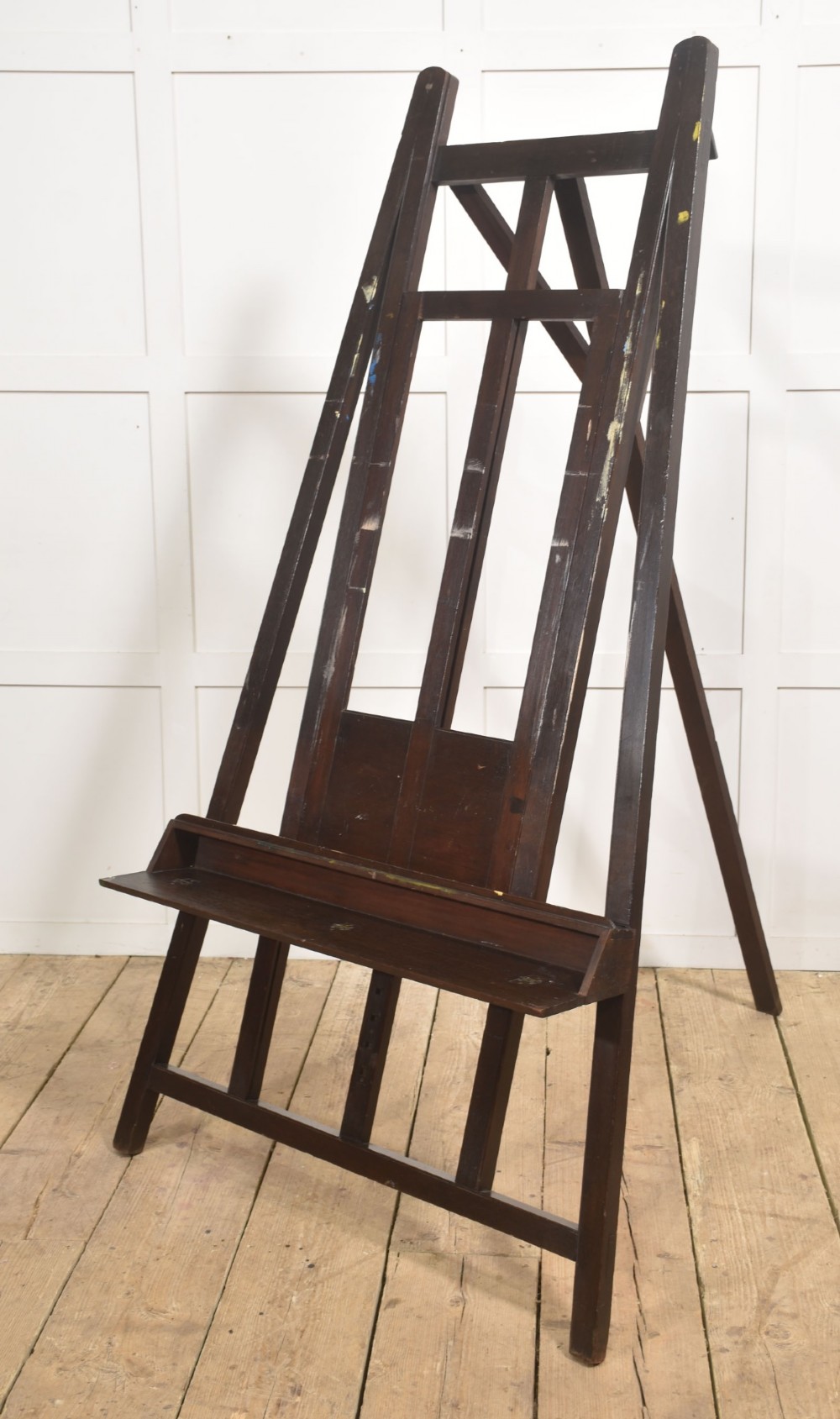 A large 19th-century mahogany floor-standing studio easel with a central adjustable shelf and an A-frame structure. View V