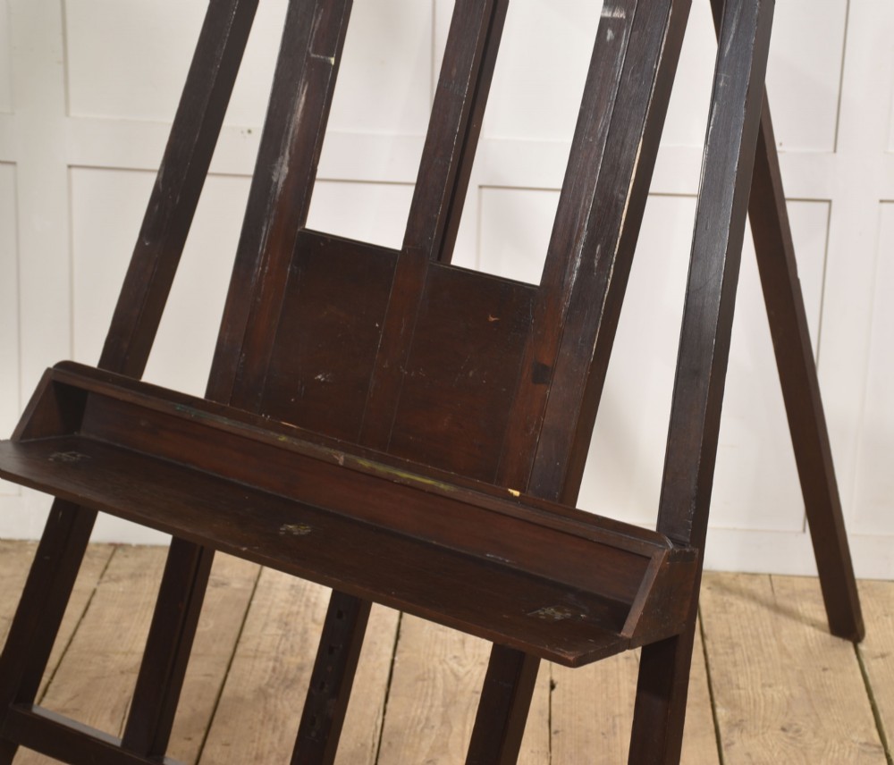 A large 19th-century mahogany floor-standing studio easel with a central adjustable shelf and an A-frame structure. View VI