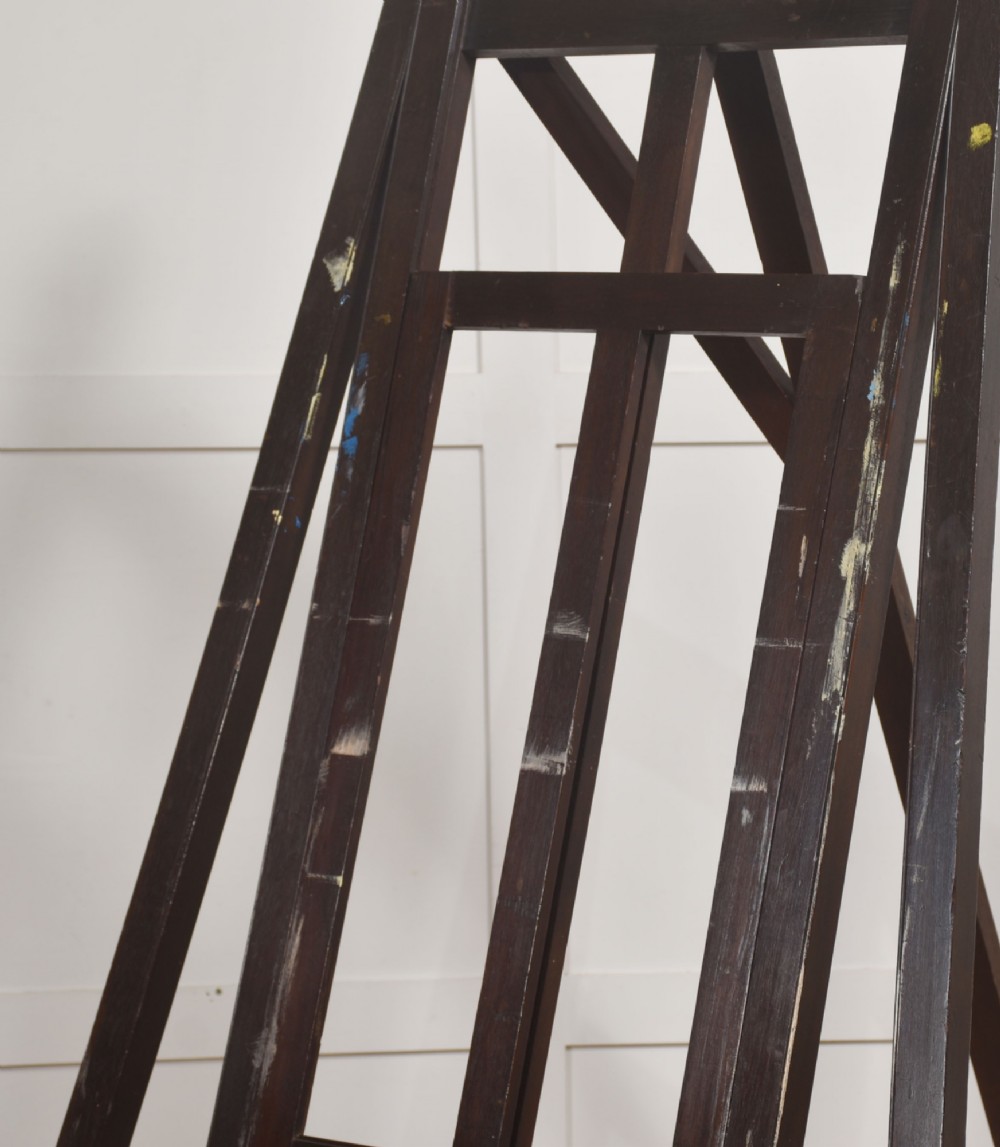 A large 19th-century mahogany floor-standing studio easel with a central adjustable shelf and an A-frame structure. View VII