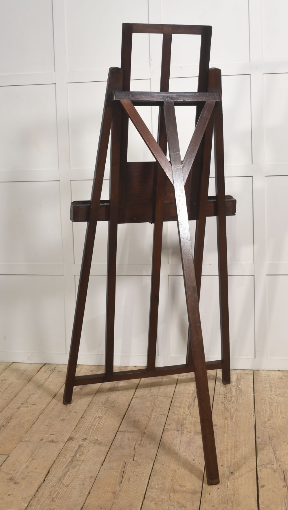 A large 19th-century mahogany floor-standing studio easel with a central adjustable shelf and an A-frame structure. View X