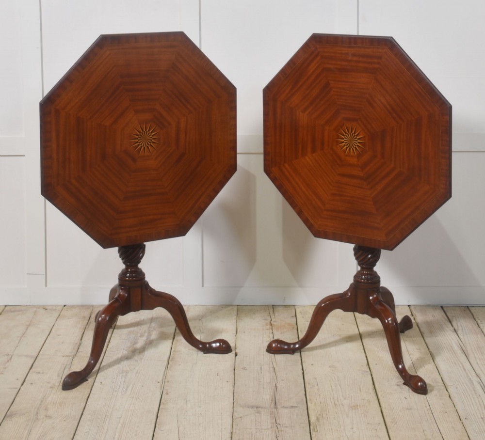 A matching pair of octagonal mahogany tripod tables featuring central starburst marquetry inlays, spiral twist turned columns, and three cabriole legs. View VI