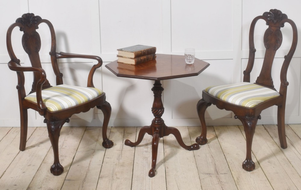 A matching pair of octagonal mahogany tripod tables featuring central starburst marquetry inlays, spiral twist turned columns, and three cabriole legs. View VII