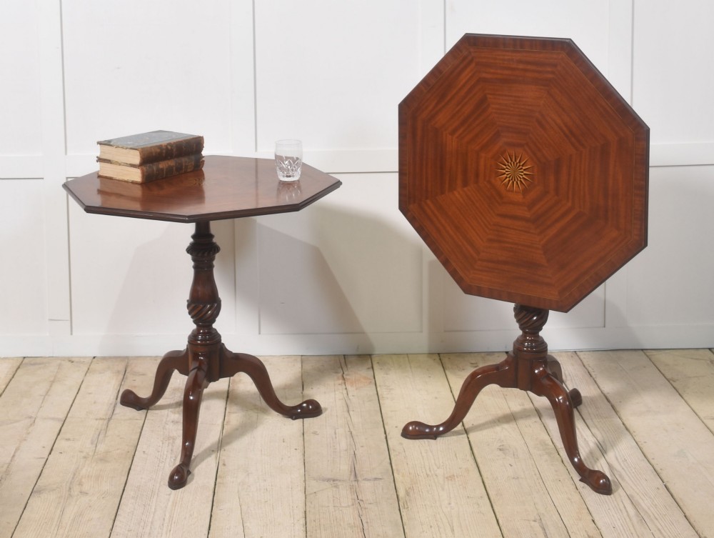 A matching pair of octagonal mahogany tripod tables featuring central starburst marquetry inlays, spiral twist turned columns, and three cabriole legs. View VIII
