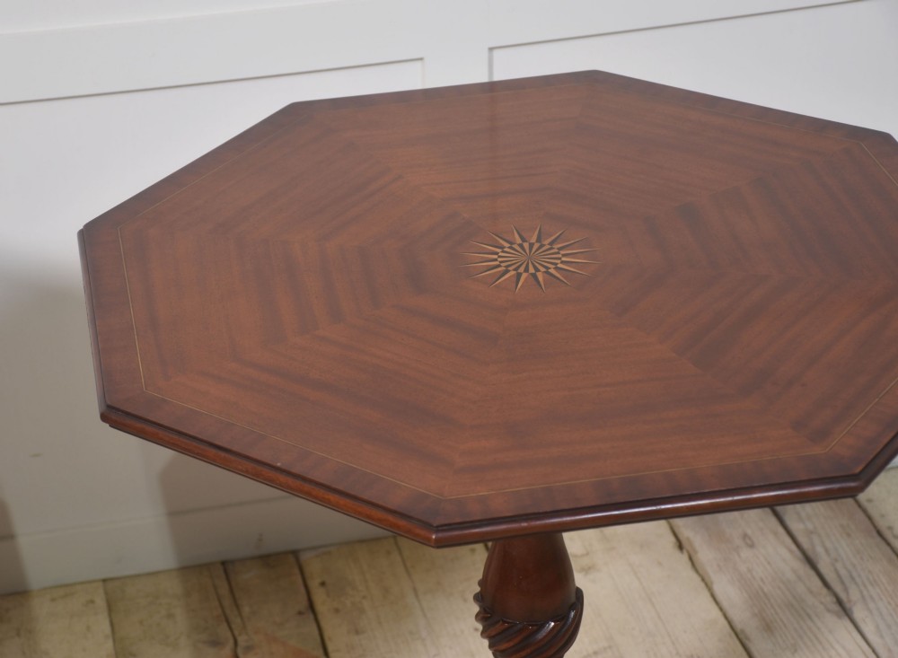 A matching pair of octagonal mahogany tripod tables featuring central starburst marquetry inlays, spiral twist turned columns, and three cabriole legs. View XII
