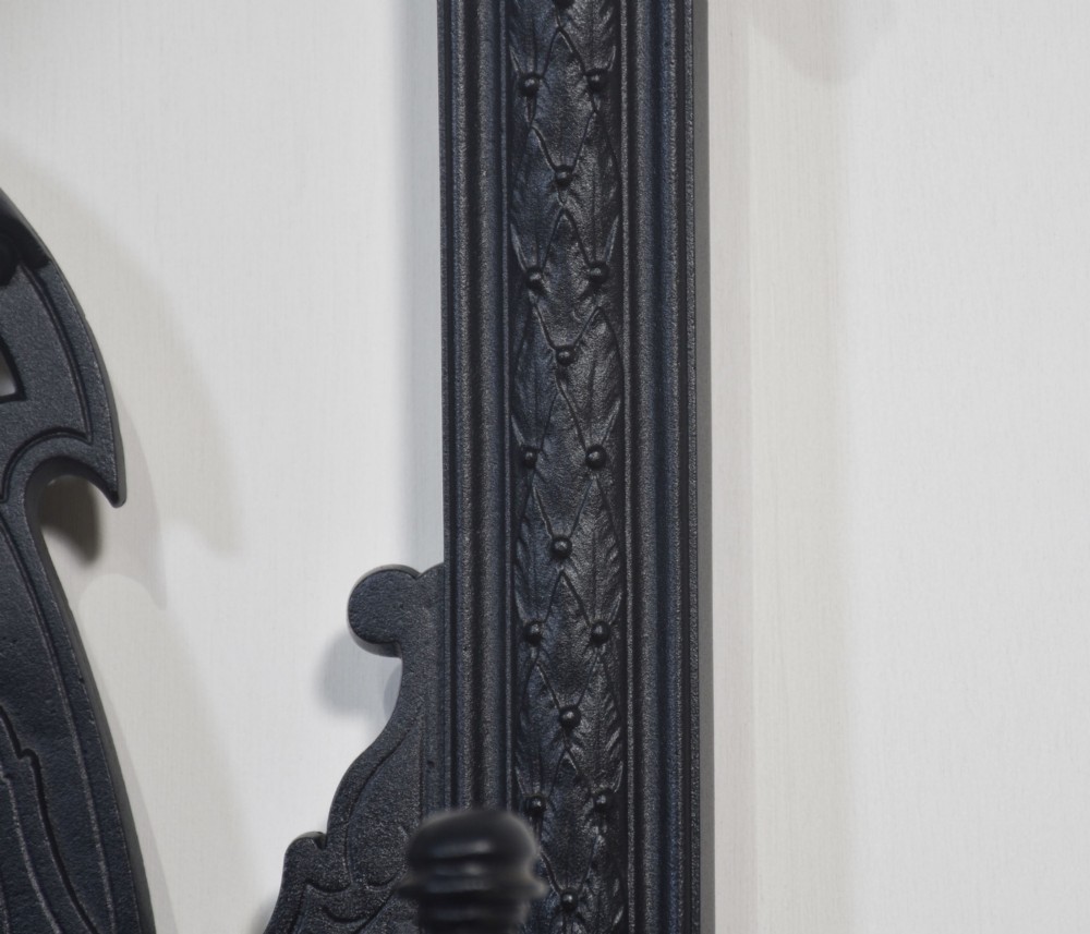 A tall black cast iron hall stand in the Coalbrookdale style featuring intricate scrollwork, coat hooks, an umbrella rail, and a drip tray base. View IX