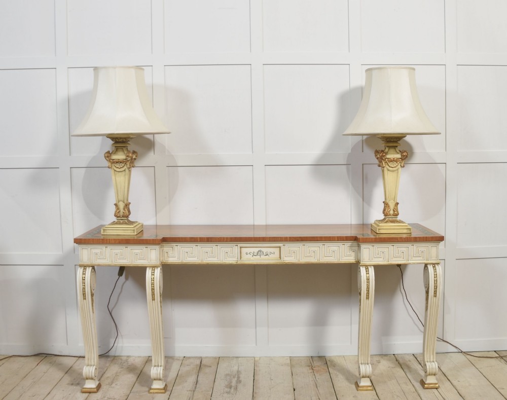 A long Neoclassical style console table featuring a polished timber top with an inlaid border, an off-white apron decorated with a painted Greek key pattern, and carved scroll legs with gilt detailing. View V