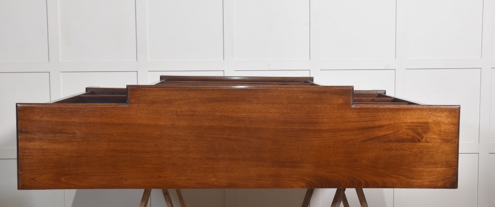 A large mahogany breakfront open library bookcase featuring multiple shelves, a fluted frieze with carved medallions, and sturdy bracket feet. View XIV
