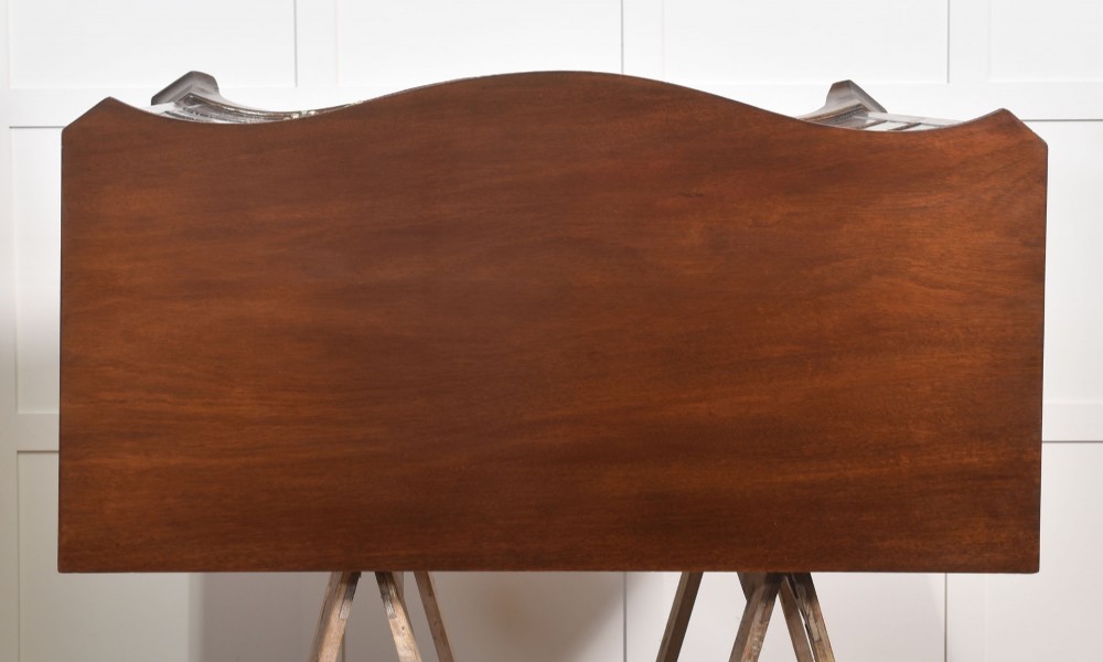 An Edwardian figured mahogany bow front chest of drawers featuring two short over three long drawers with brass swan-neck handles and splayed bracket feet. View XII