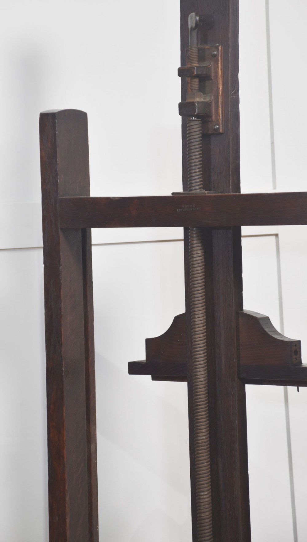 A nineteenth-century dark oak artist studio easel featuring a winding crank handle mechanism and castors on the base. View VIII