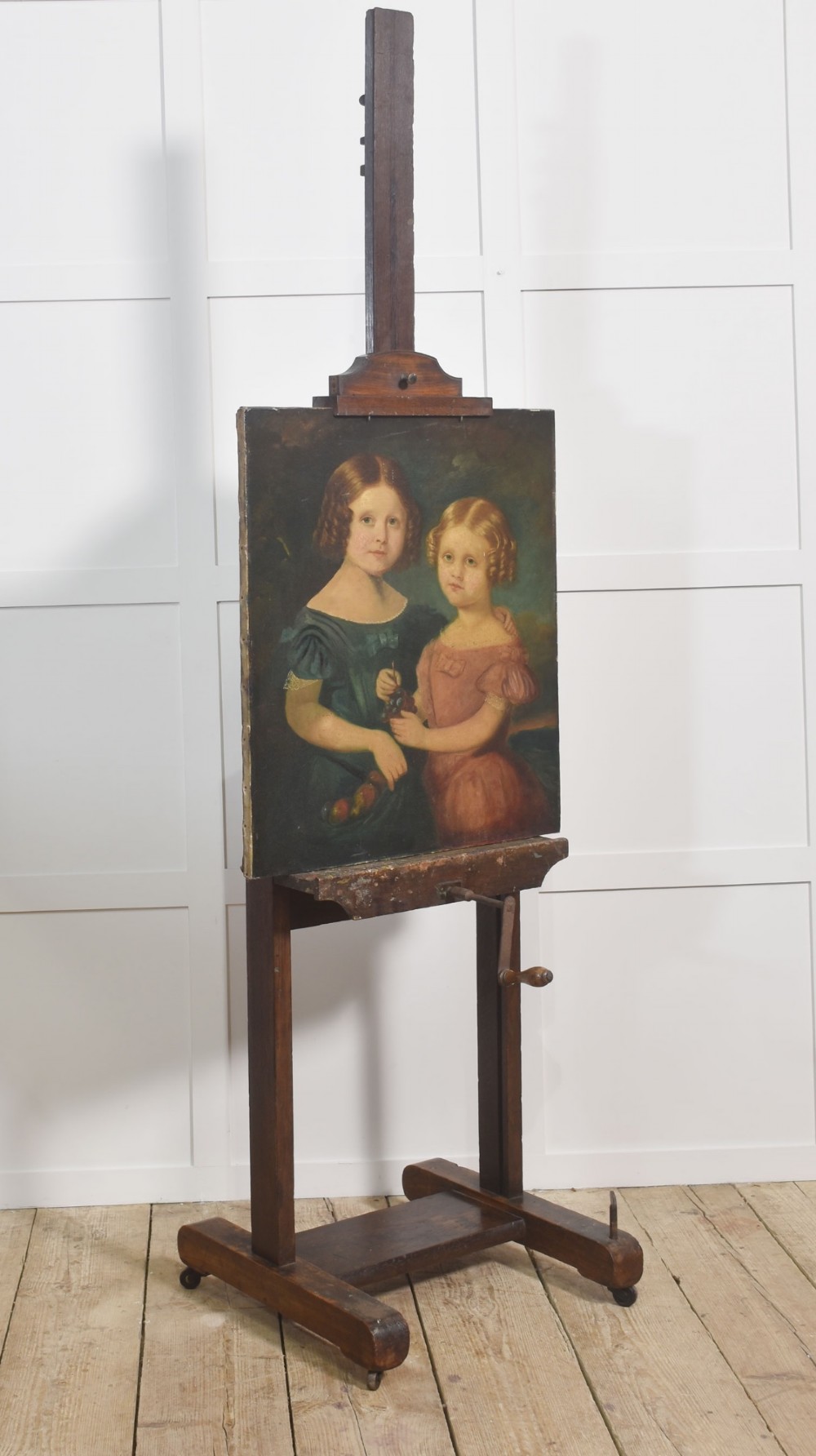 A nineteenth-century dark oak artist studio easel featuring a winding crank handle mechanism and castors on the base. View IX