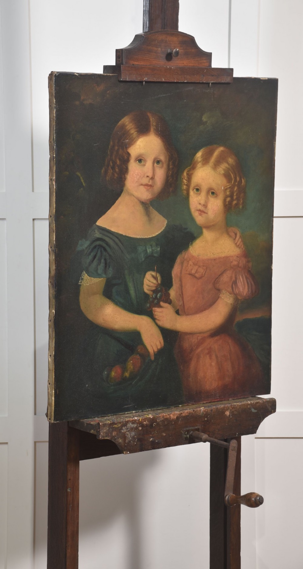 A nineteenth-century dark oak artist studio easel featuring a winding crank handle mechanism and castors on the base. View X