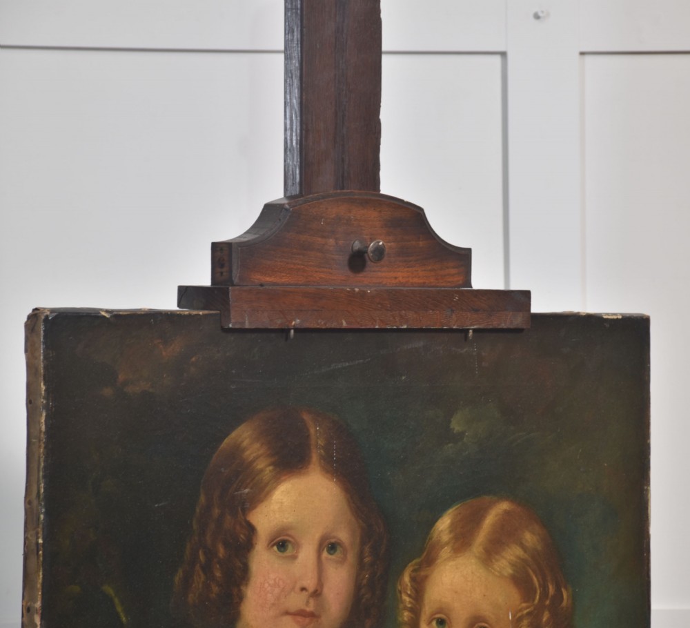 A nineteenth-century dark oak artist studio easel featuring a winding crank handle mechanism and castors on the base. View XI
