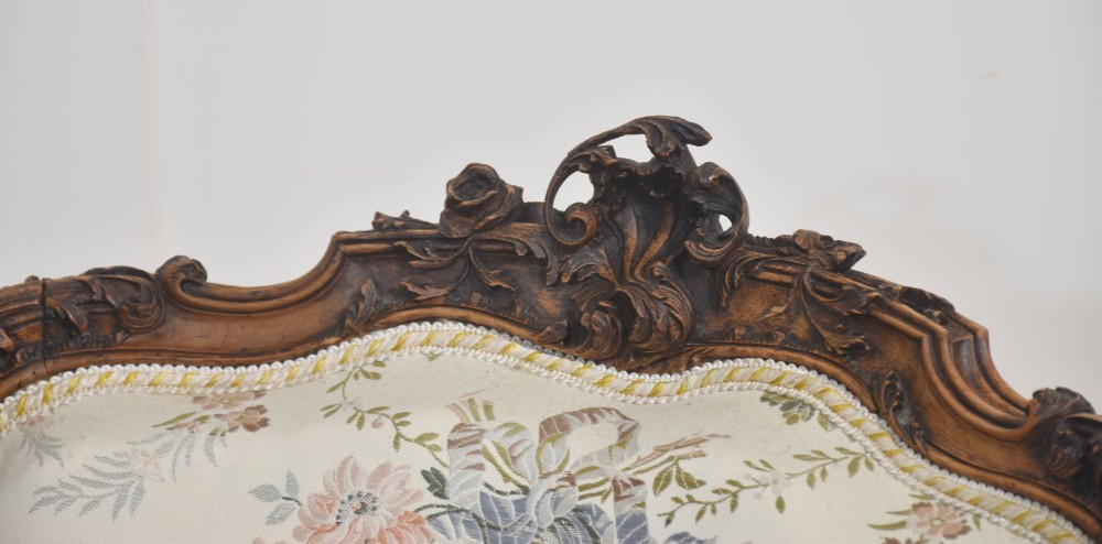 A pair of French carved walnut open armchairs featuring floral tapestry upholstery and cabriole legs. View XI