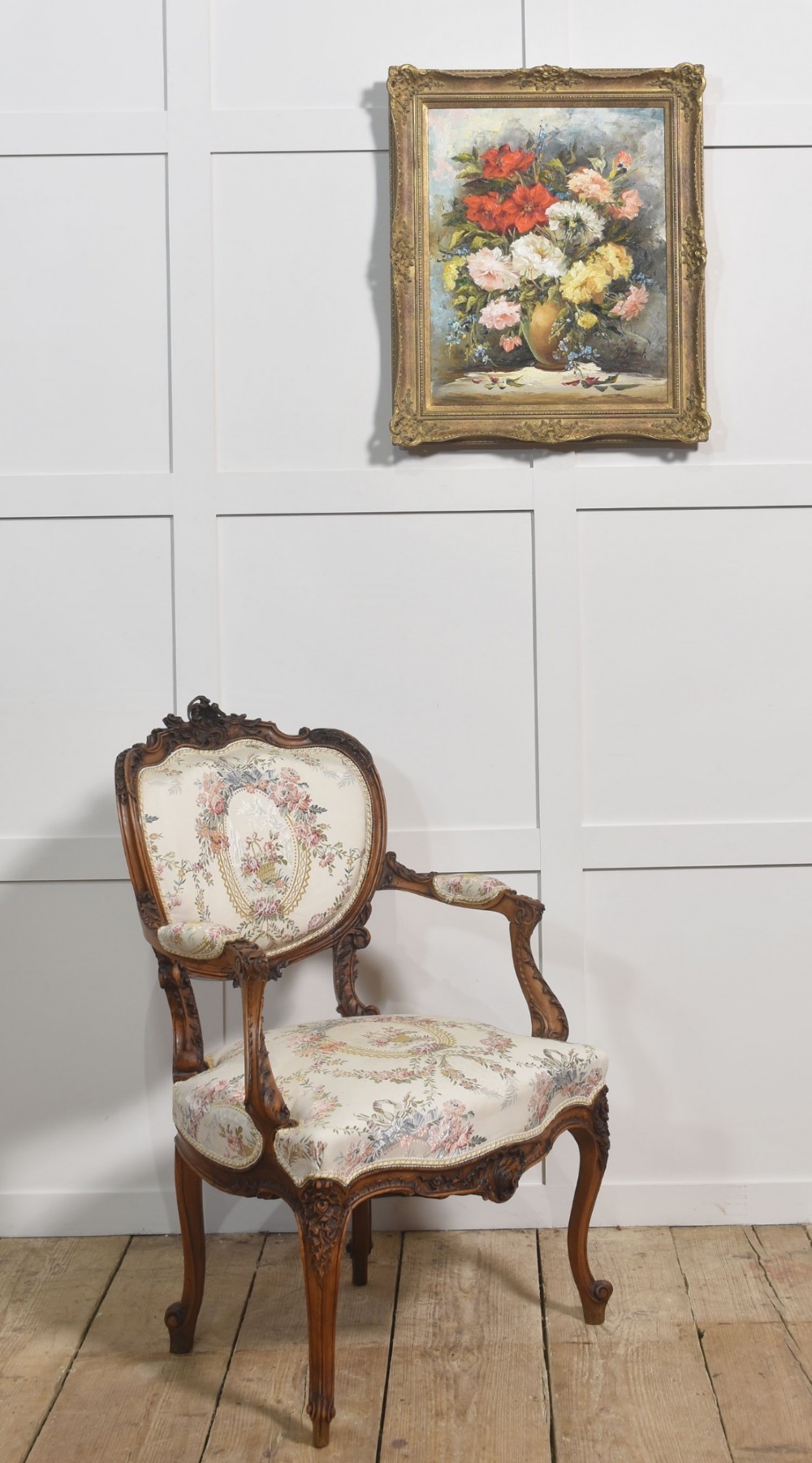 A pair of French carved walnut open armchairs featuring floral tapestry upholstery and cabriole legs. View XIII