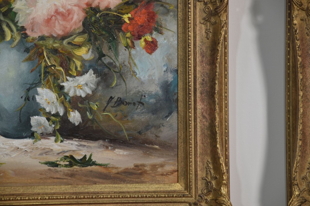 A pair of framed oil paintings depicting colourful arrangements of flowers in ceramic vases set within ornate gilded frames. View VII