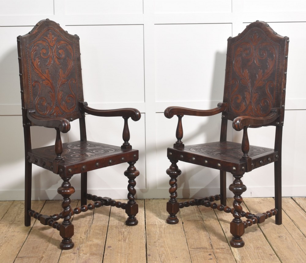 A set of eight dark brown walnut dining chairs featuring embossed floral leather seats and backrests with decorative studding and barley twist legs. View IV