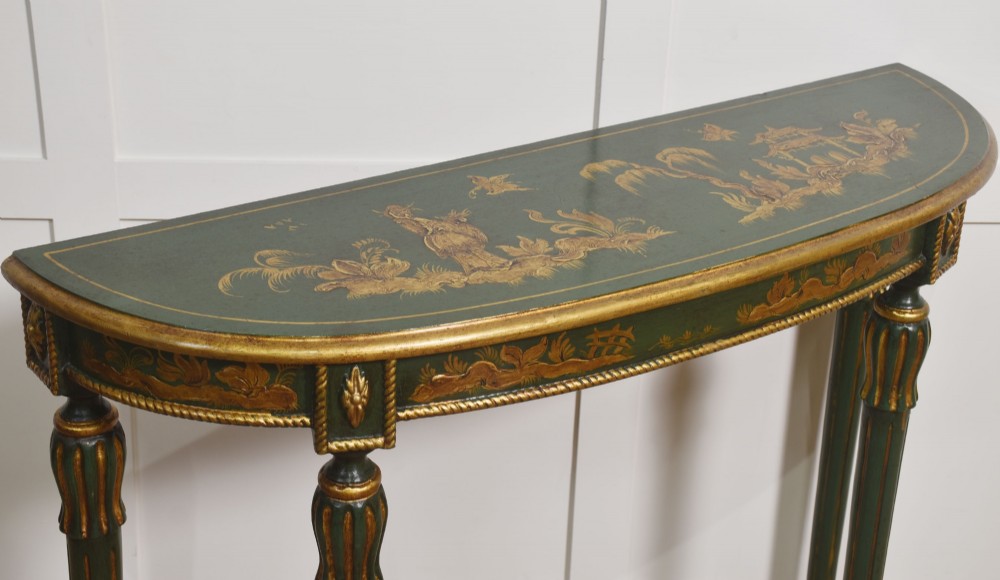 A dark green demi-lune console table with hand-painted gold chinoiserie decoration along the frieze and fluted tapered legs. View VI