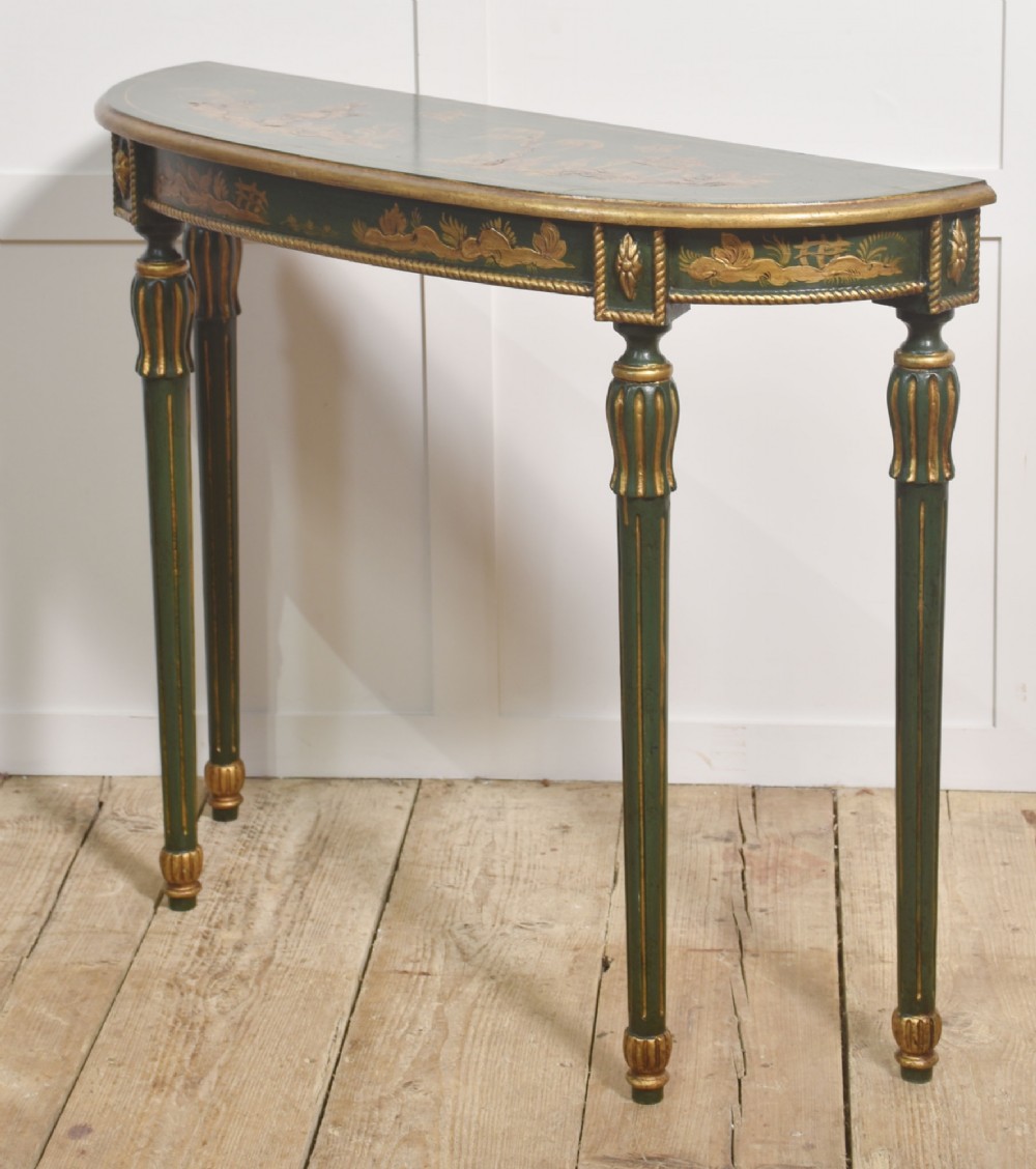 A dark green demi-lune console table with hand-painted gold chinoiserie decoration along the frieze and fluted tapered legs. View VII