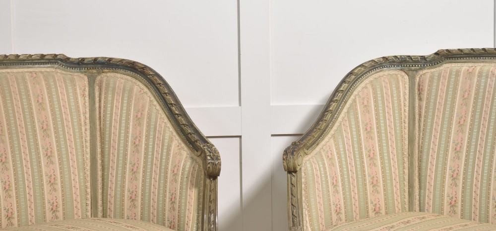 A pair of grey-painted French tub armchairs upholstered in a striped floral pastel fabric with fluted legs. View III