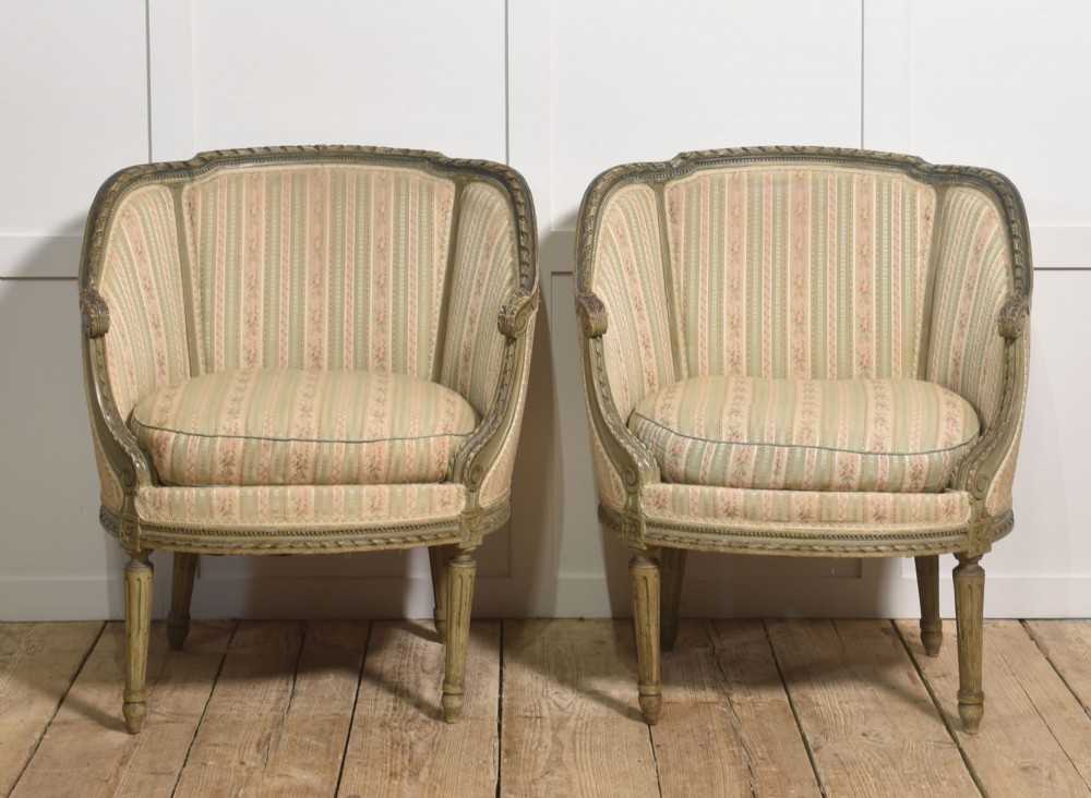 A pair of grey-painted French tub armchairs upholstered in a striped floral pastel fabric with fluted legs. View VI
