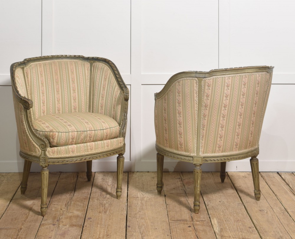 A pair of grey-painted French tub armchairs upholstered in a striped floral pastel fabric with fluted legs. View VIII