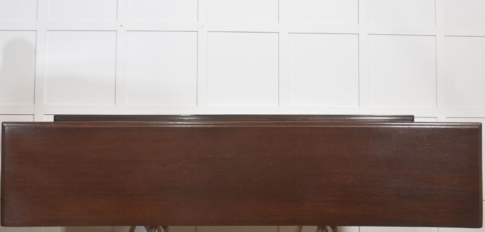 A dark oak Jacobean style dresser base featuring three drawers with decorative brass handles, turned baluster legs, and a full-length lower pot board shelf. View XII