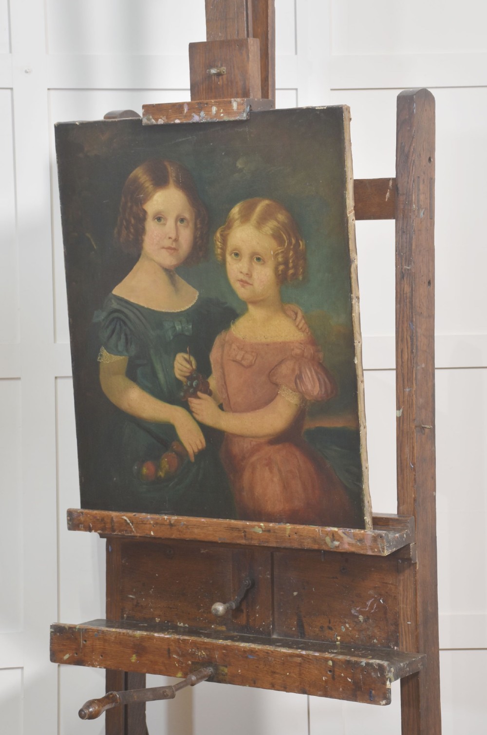 A late nineteenth-century dark oak artist studio easel featuring an adjustable central shaft, crank handle, and cast iron castors on an H-frame base. View VIII