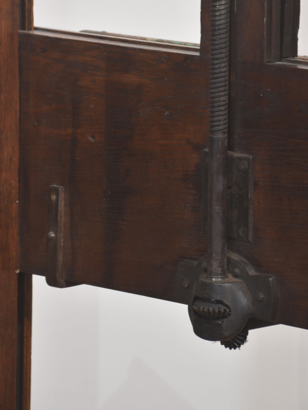 A late nineteenth-century dark oak artist studio easel featuring an adjustable central shaft, crank handle, and cast iron castors on an H-frame base. View XIII