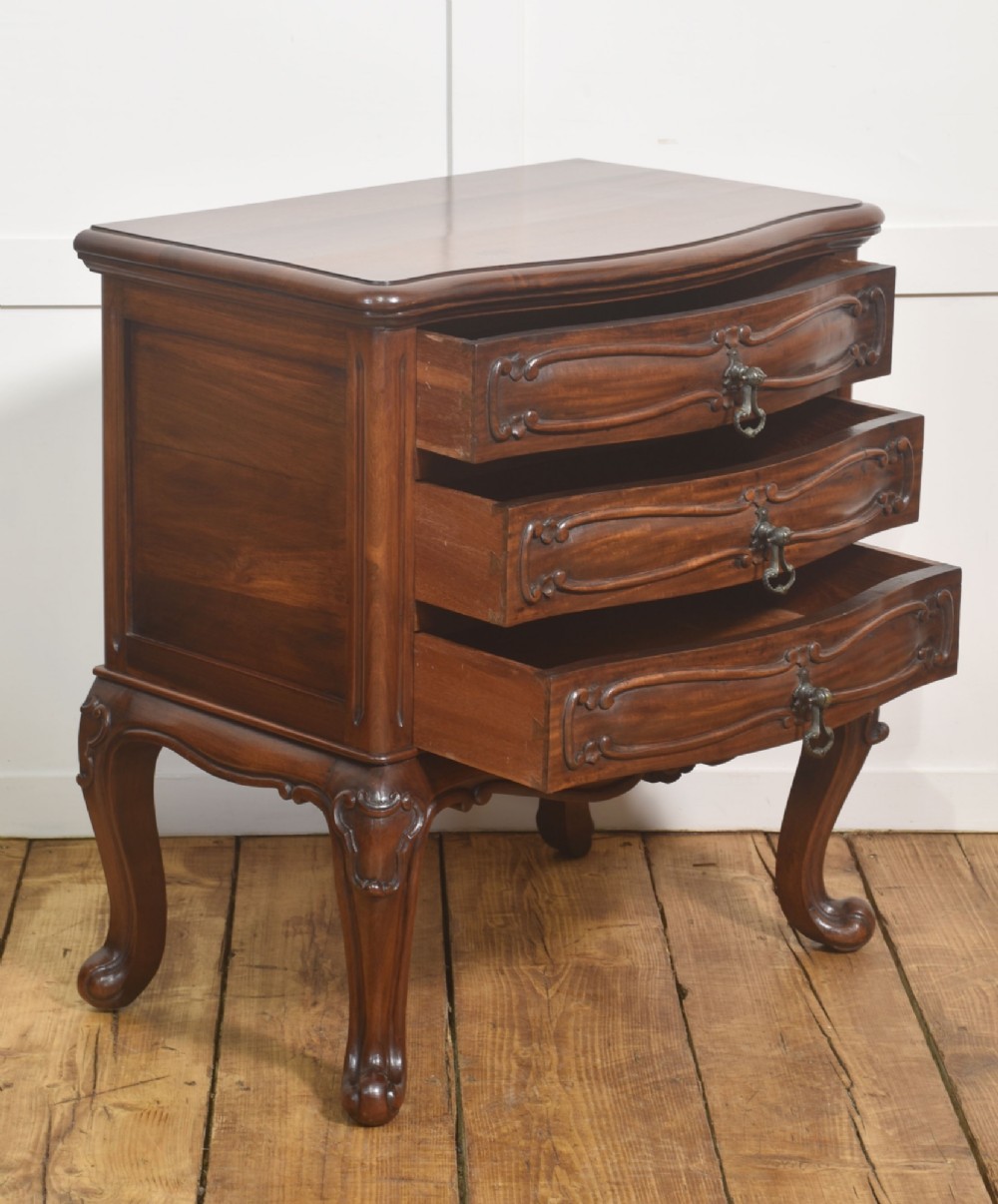A French Louis XV style walnut chest featuring three carved drawers elevated on cabriole legs with brass drop handles. View III