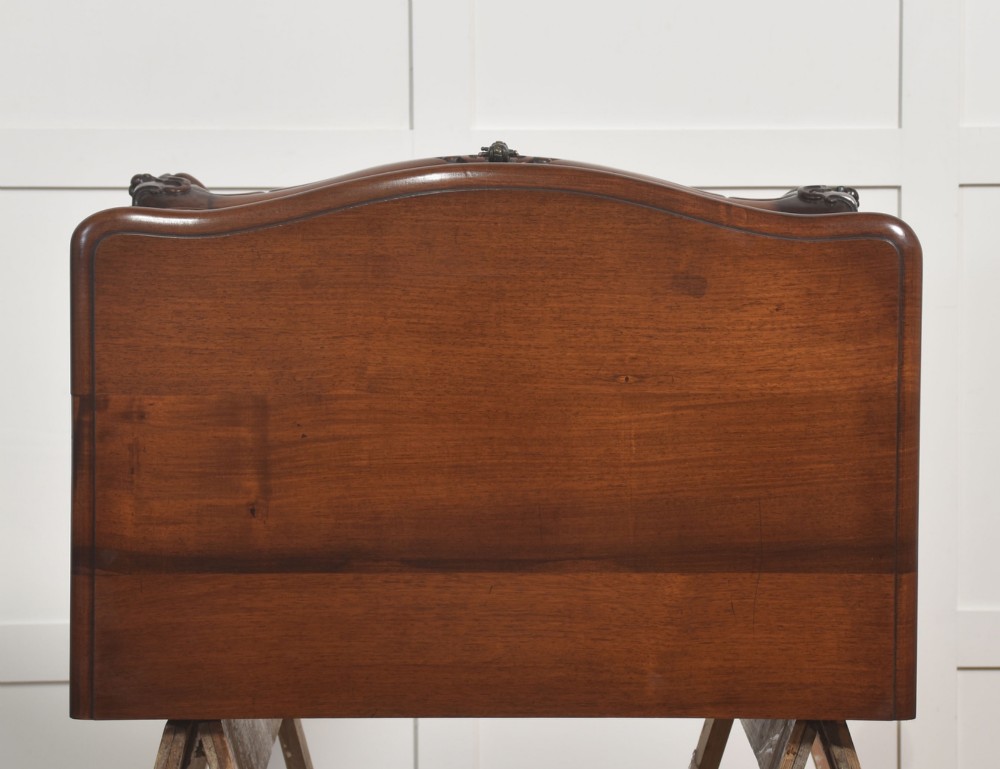 A French Louis XV style walnut chest featuring three carved drawers elevated on cabriole legs with brass drop handles. View IX