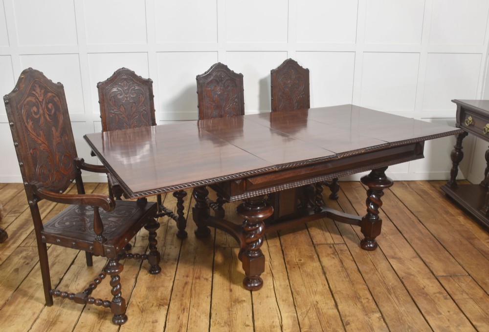 A large 19th-century Portuguese rosewood extending dining table with carved barley-twist legs, an H-stretcher base, and two removable extension leaves standing behind it. View III