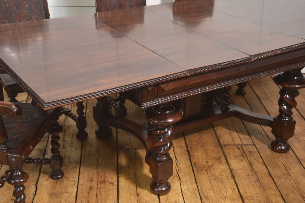A large 19th-century Portuguese rosewood extending dining table with carved barley-twist legs, an H-stretcher base, and two removable extension leaves standing behind it. View IV