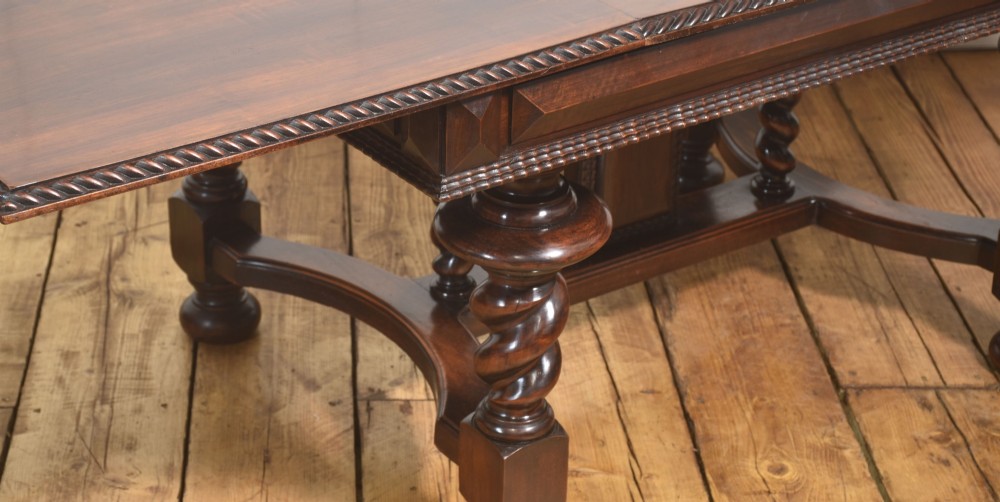 A large 19th-century Portuguese rosewood extending dining table with carved barley-twist legs, an H-stretcher base, and two removable extension leaves standing behind it. View VI