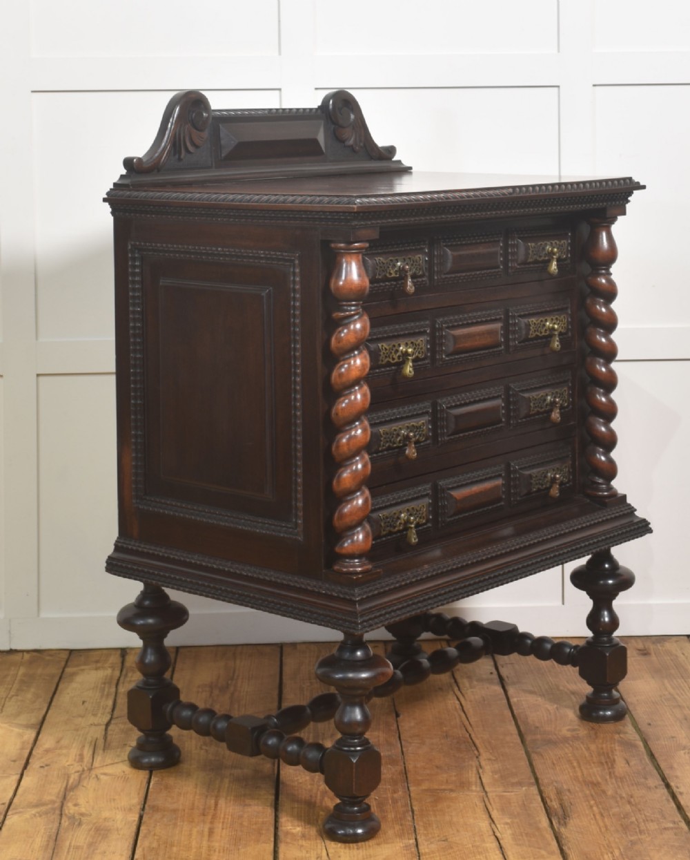 A 19th-century dark rosewood chest on stand with four drawers, pierced brass drop handles, barley twist side columns, and turned legs. View III