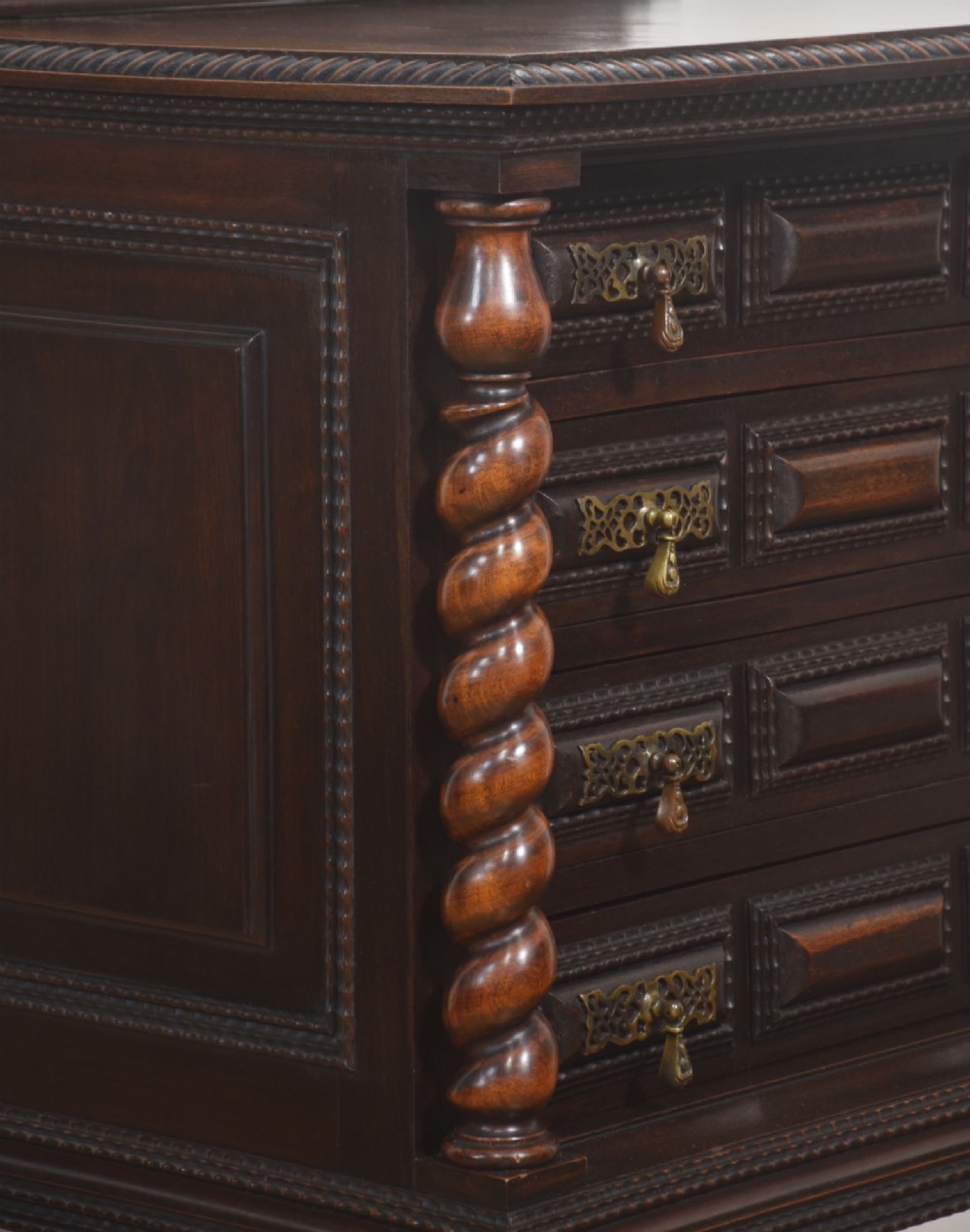 A 19th-century dark rosewood chest on stand with four drawers, pierced brass drop handles, barley twist side columns, and turned legs. View IV